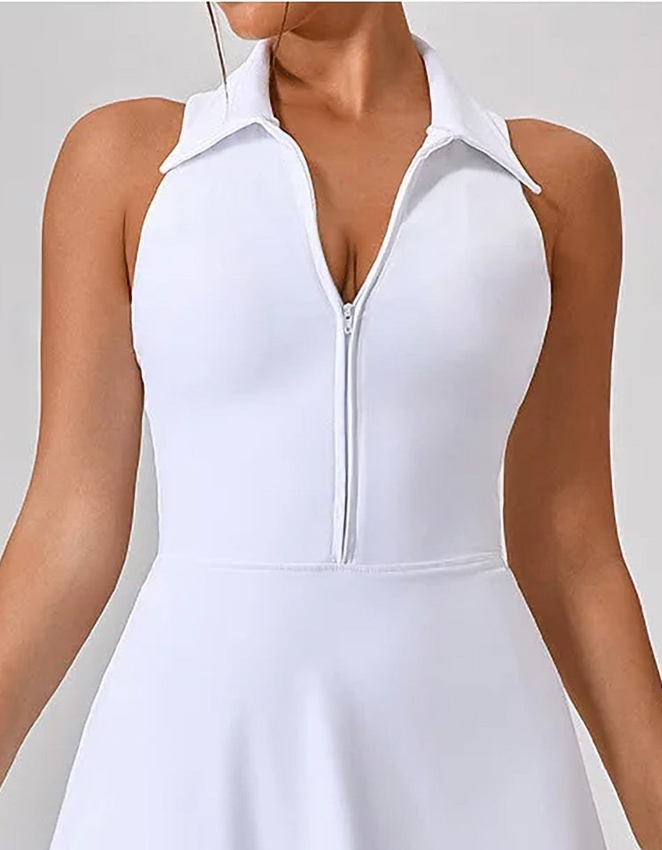 Person wearing a white sleeveless dress on a plain background