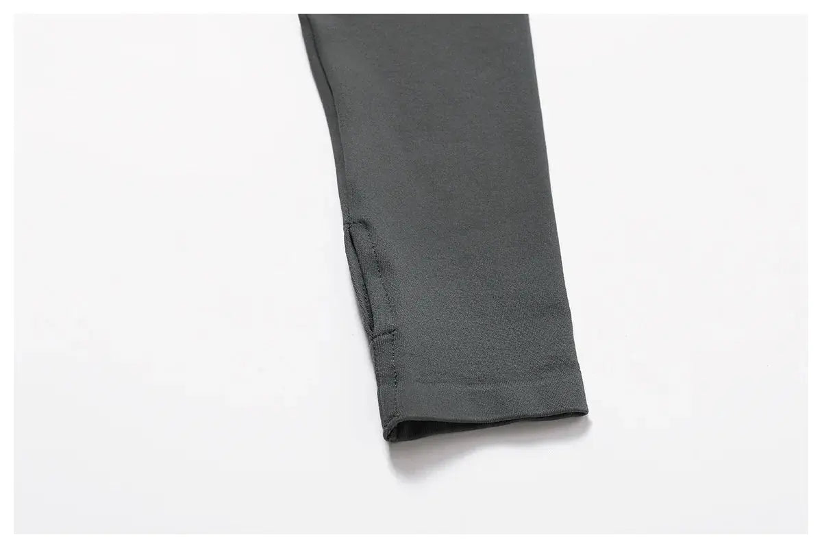 A close-up of the lower sleeve of the Mirèlle Workout Jacket with Zip & Quick Dry in dark gray, displayed on a white background. The sweat-wicking, slightly stretchy fabric has visible stitching along the edges.