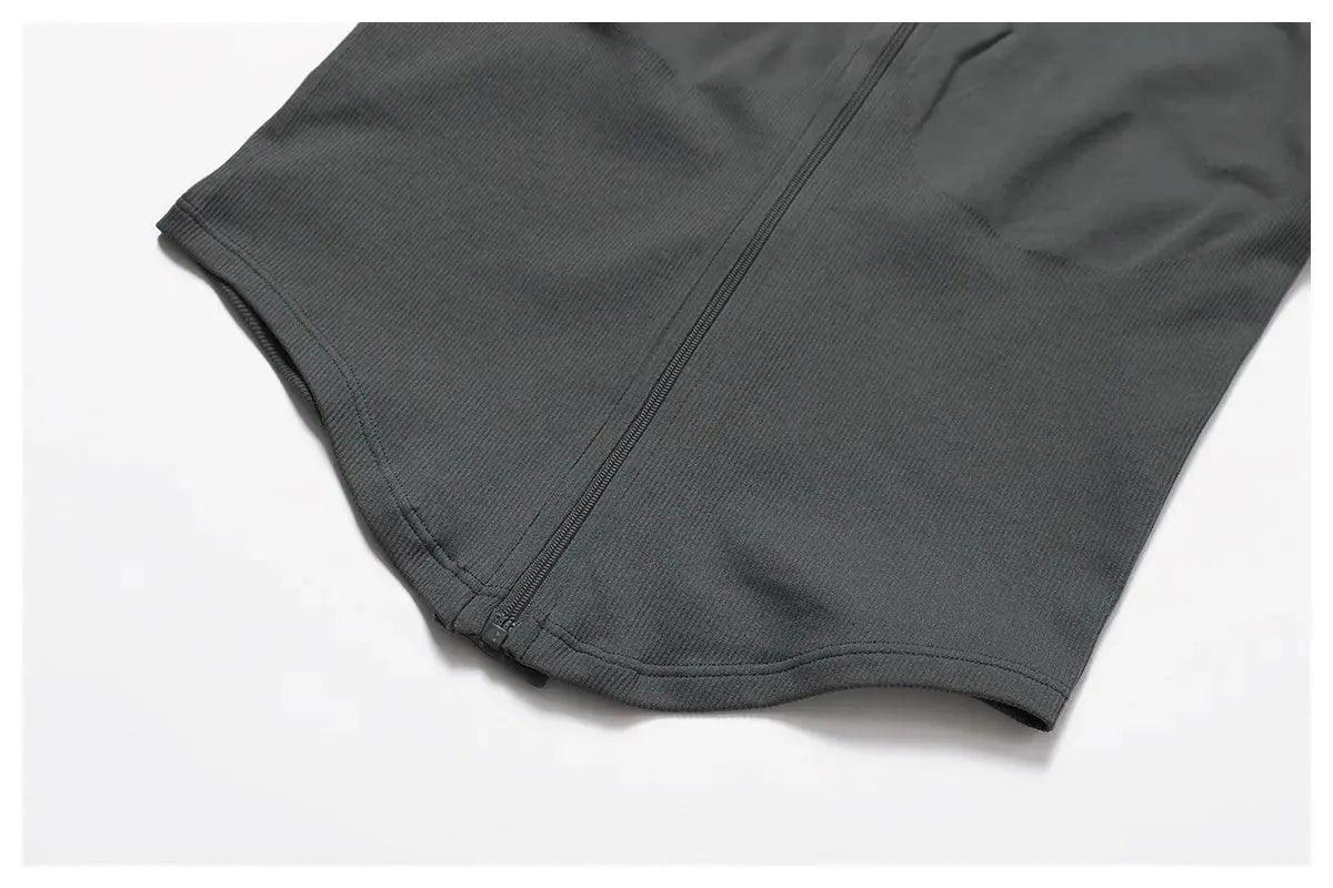 A close-up of the Mirèlle Workout Jacket with Zip & Quick Dry in dark gray, showing its textured, sweat-wicking fabric and front zipper, laid flat on a white background.